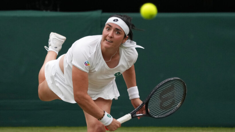 Ons Jabeur hitting a return to her opponent during a tennis match.