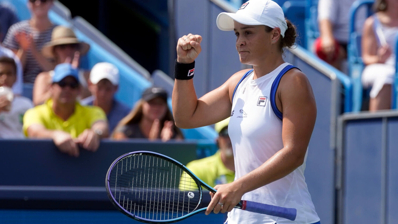 Ashleigh Barty reacting with a first pump during a tennis match.