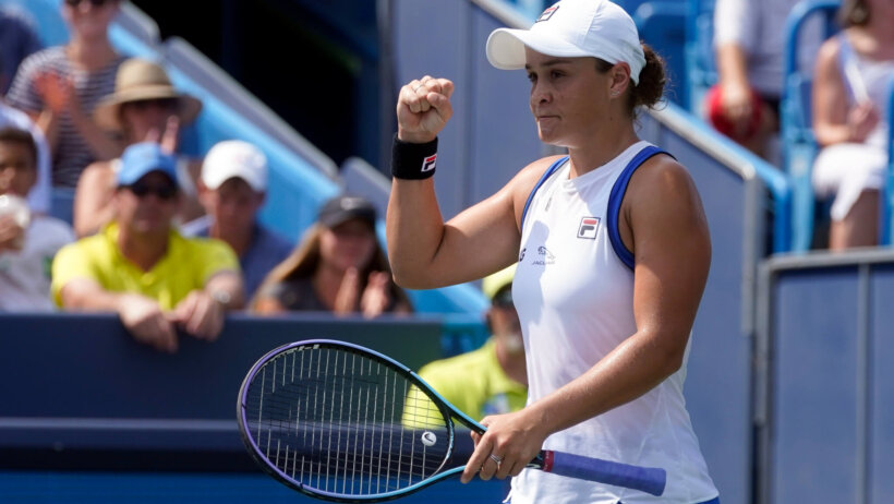 Ashleigh Barty reacting with a first pump during a tennis match.