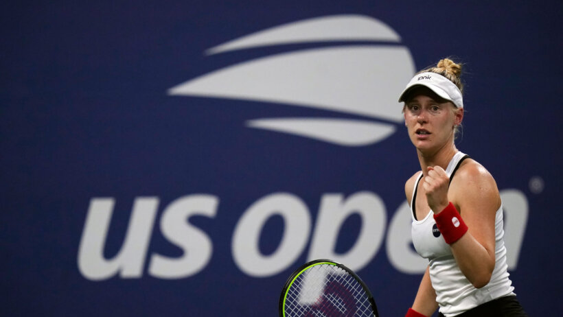 Alison Riske reacting with a fist pump during a tennis match.