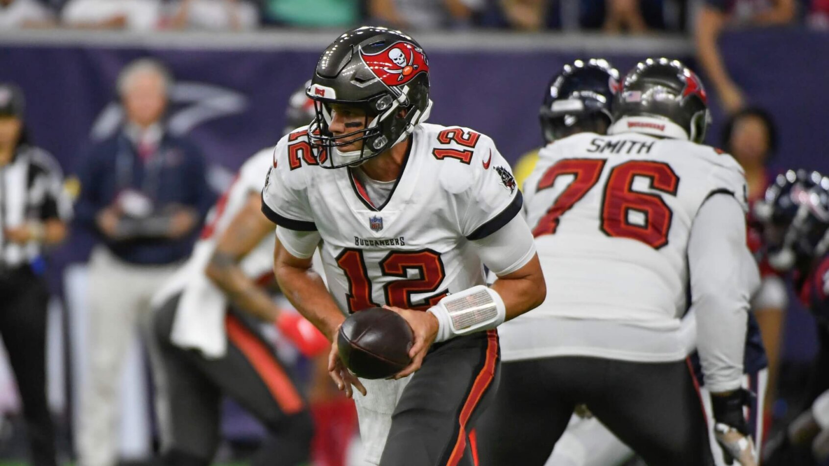 Tampa Bay Buccaneers quarterback Tom Brady handing the ball off in an NFL game.