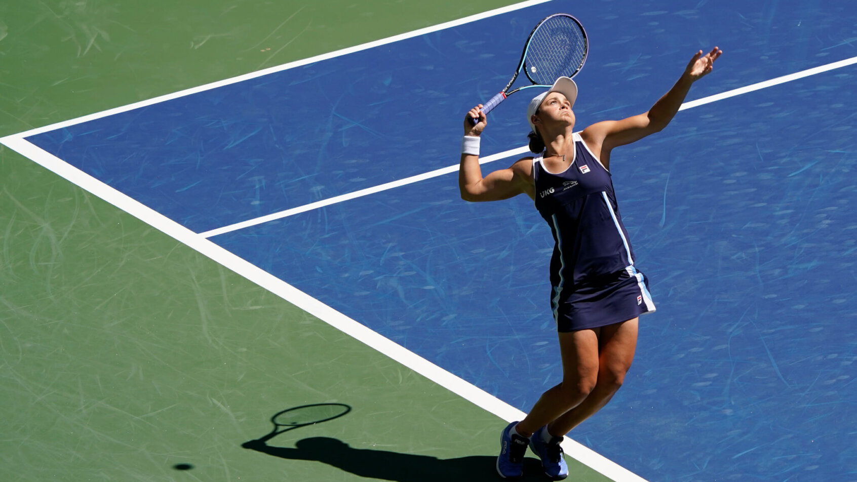 Ashleigh Barty serving the ball during a tennis match.