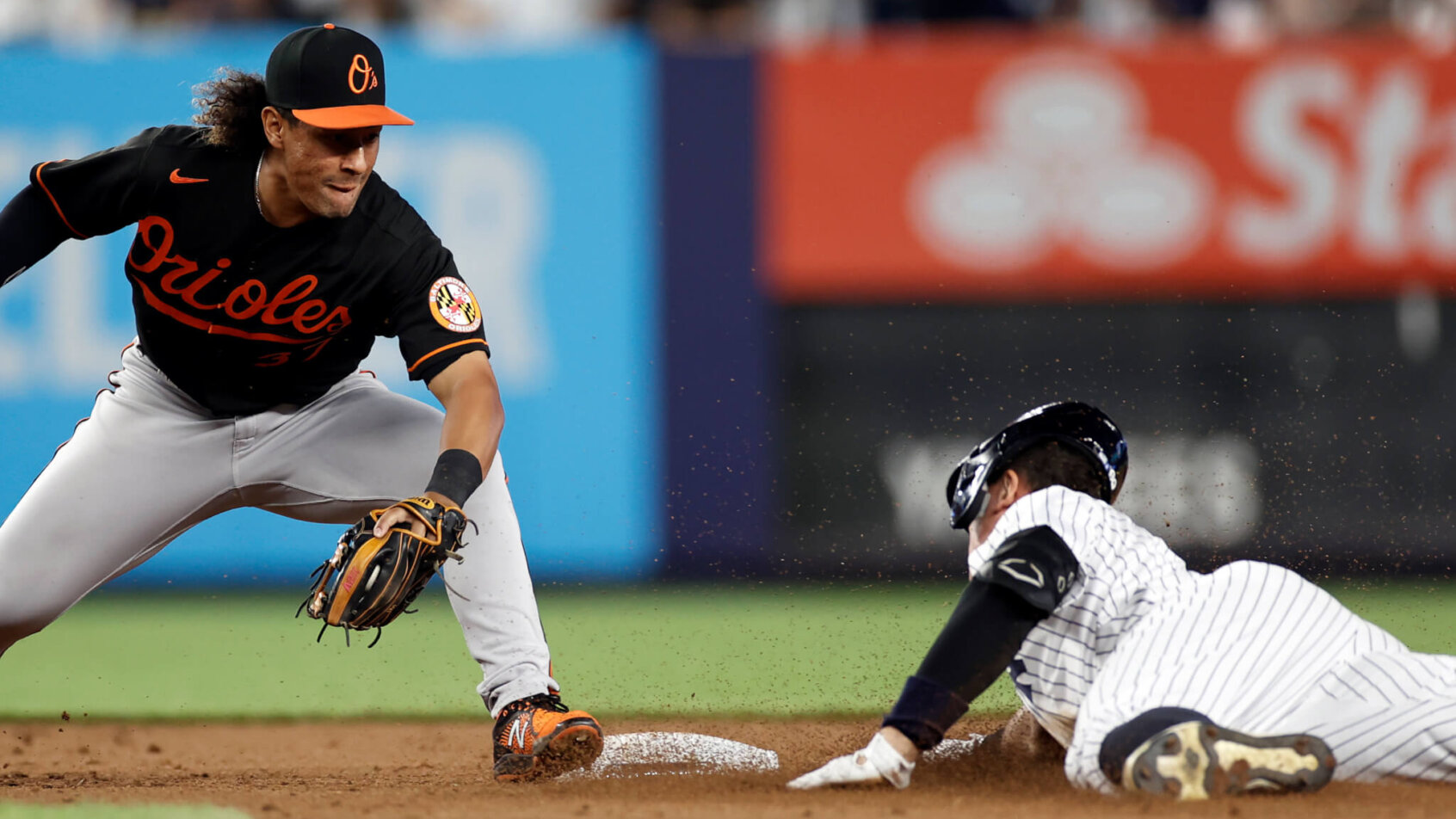 New York Yankees' Aaron Judge sliding into second base head first against the Baltimore Orioles.