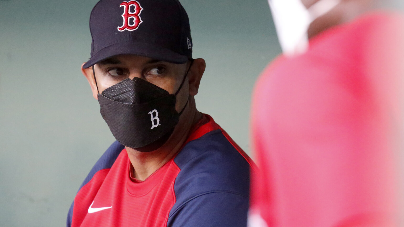 Alex Cora with mask on in dugout