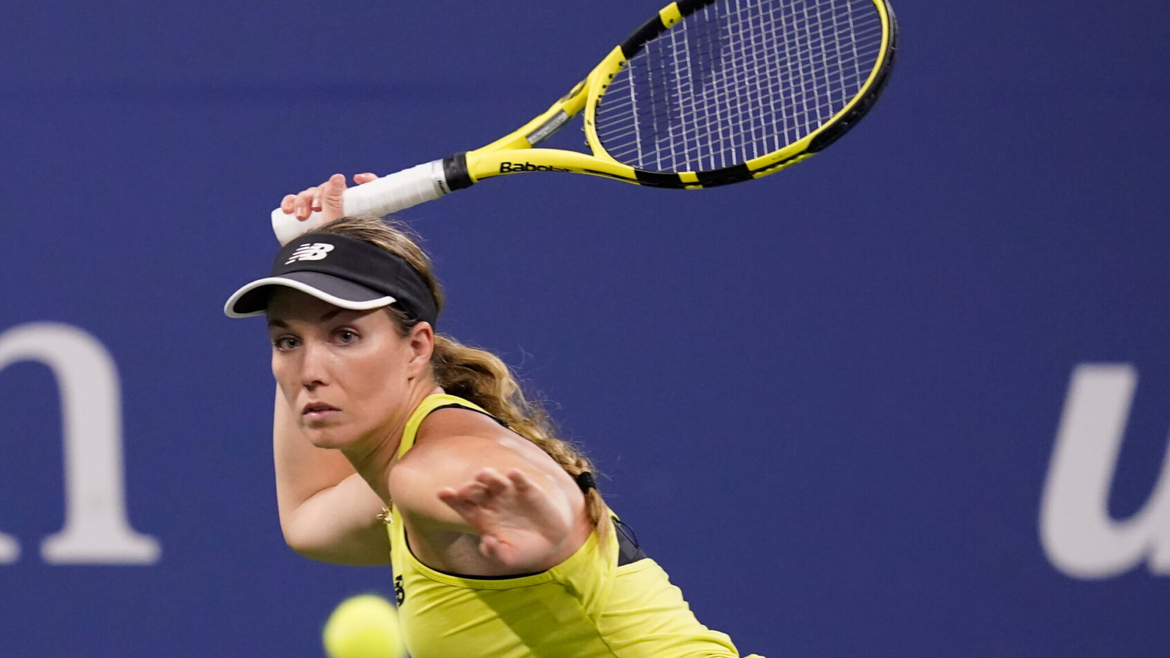 Danielle Collins hitting a return shot during a tennis match.