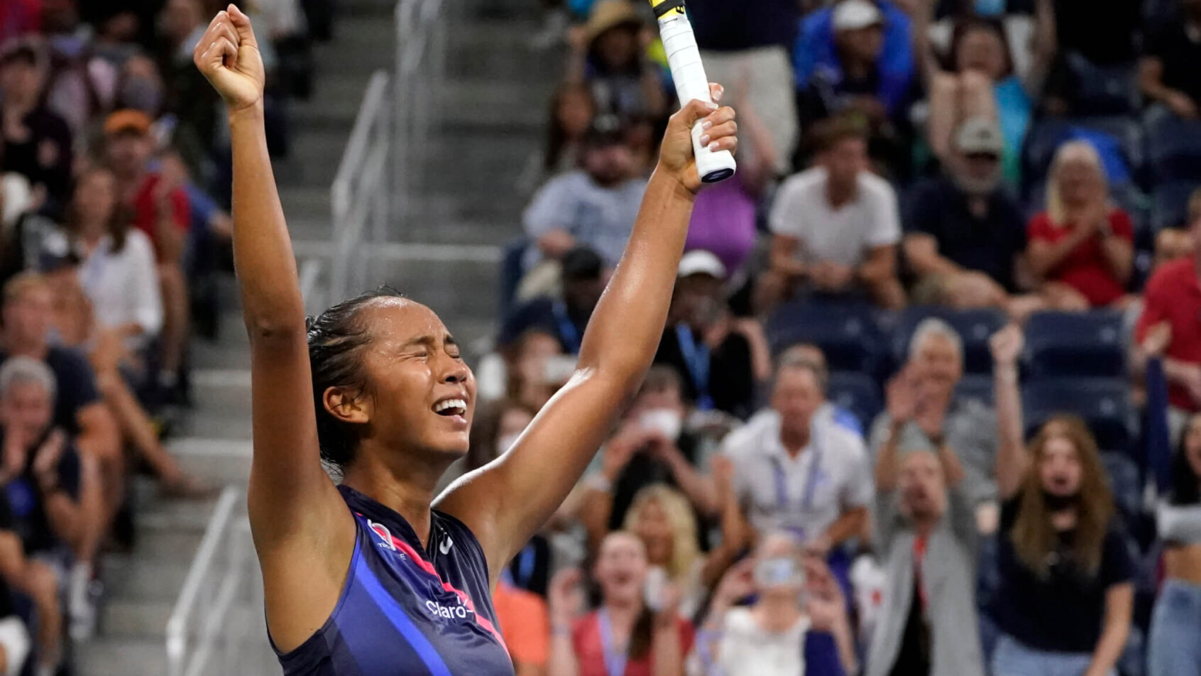 Leylah Fernandez reacting with her hands up in the air after winning a tennis match at the US Open.