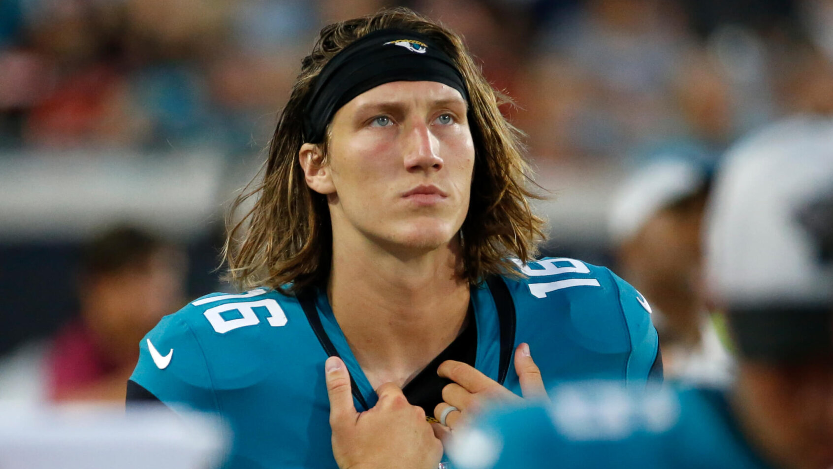 Trevor Lawrence holding front of jersey