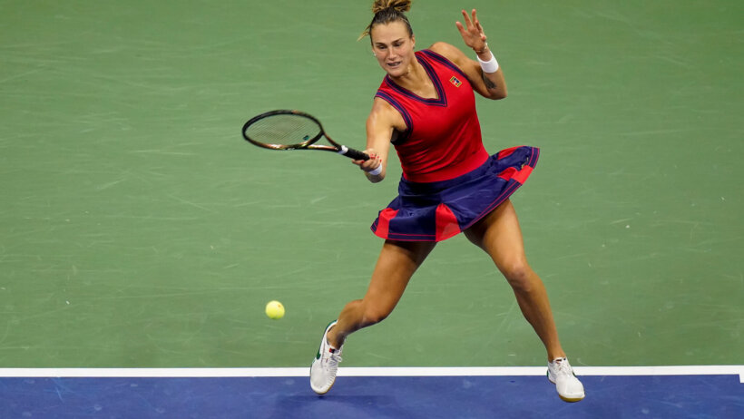 Aryna Sabalenka hitting a return shot during a tennis match.