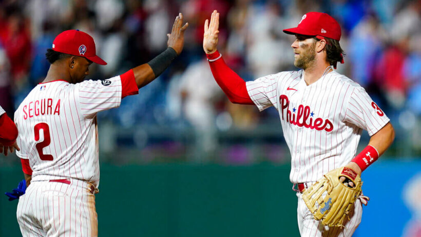 Philadelphia Phillies' Bryce Harper celebrates with Jean Segura after a win