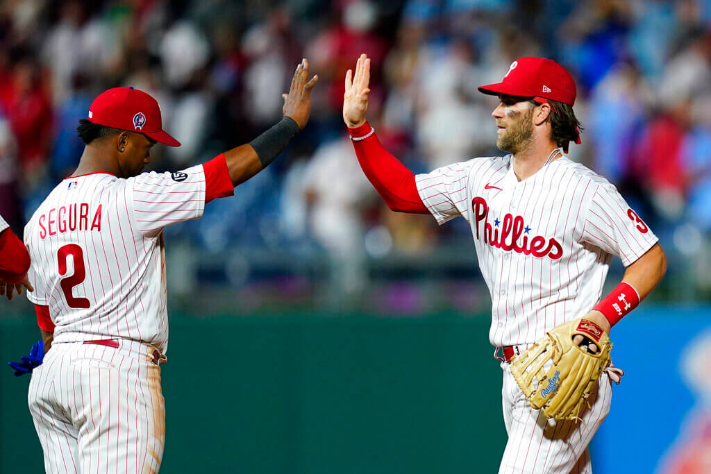 Philadelphia Phillies' Bryce Harper celebrates with Jean Segura after a win