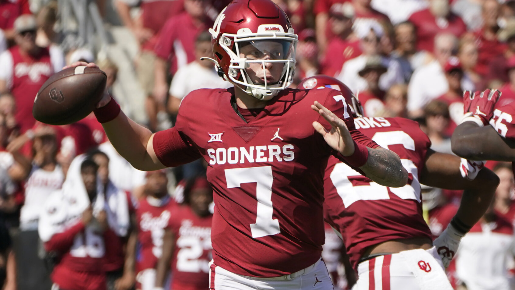 Oklahoma quarterback Spencer Rattler throwing a football during a NCAA football game.