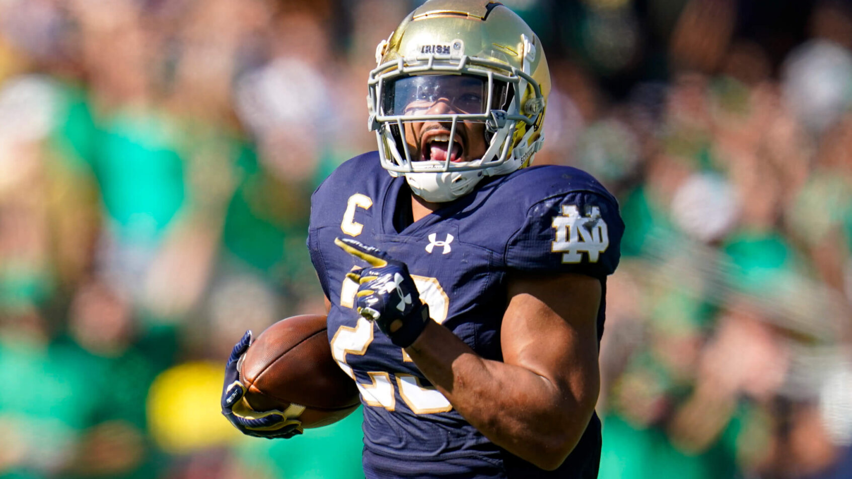 Notre Dame running back Kyren Williams running in for a touchdown during a football game.