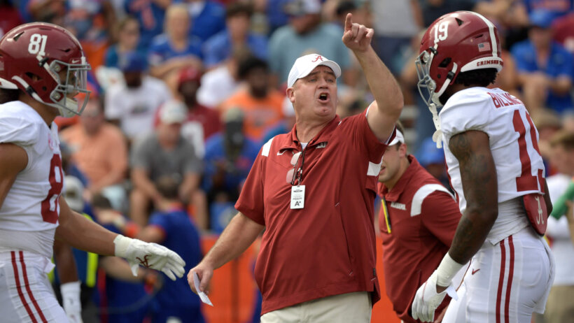 Alabama offensive coordinator Bill O'Brien calling out instructions as the team warms up before a game.