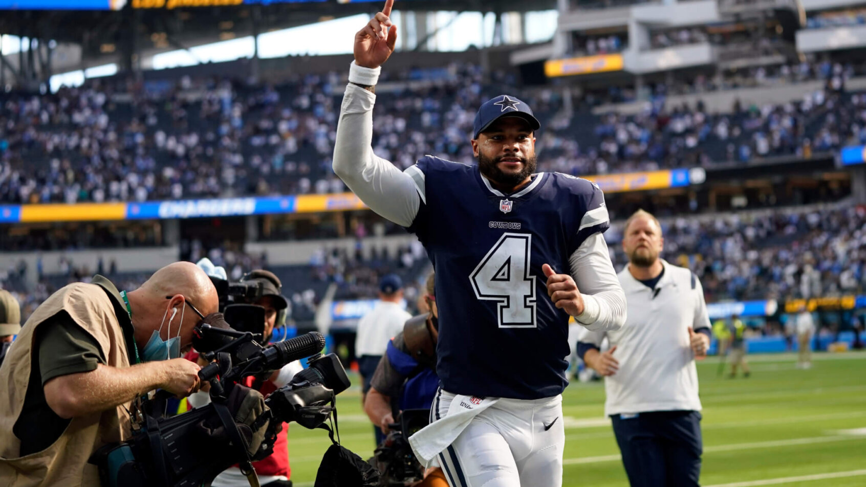 Dak Prescott running with hand in air