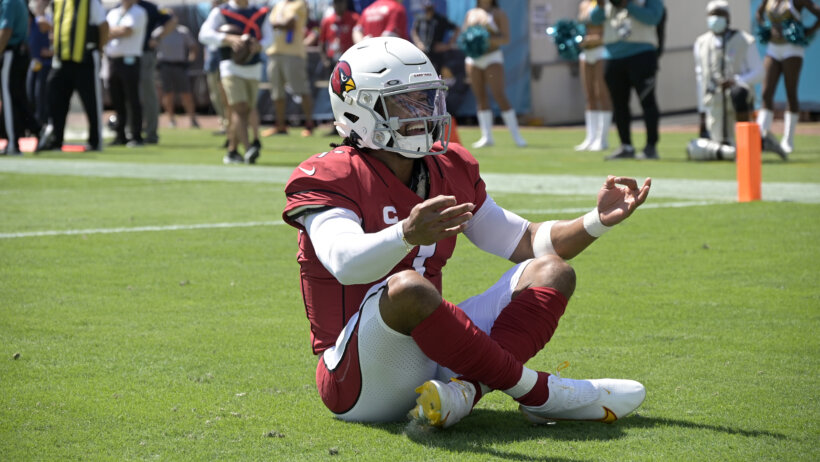 Arizona Cardinals quarterback Kyler Murray celebrating in the end zone after scoring a touchdown.