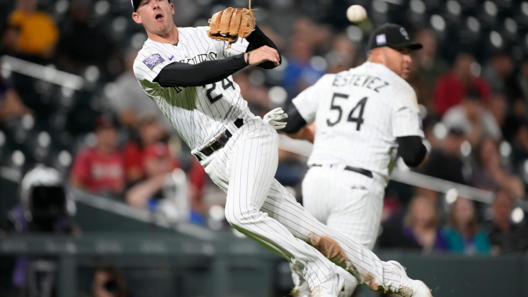 Colorado Rockies third baseman Ryan McMahon throwing to first base