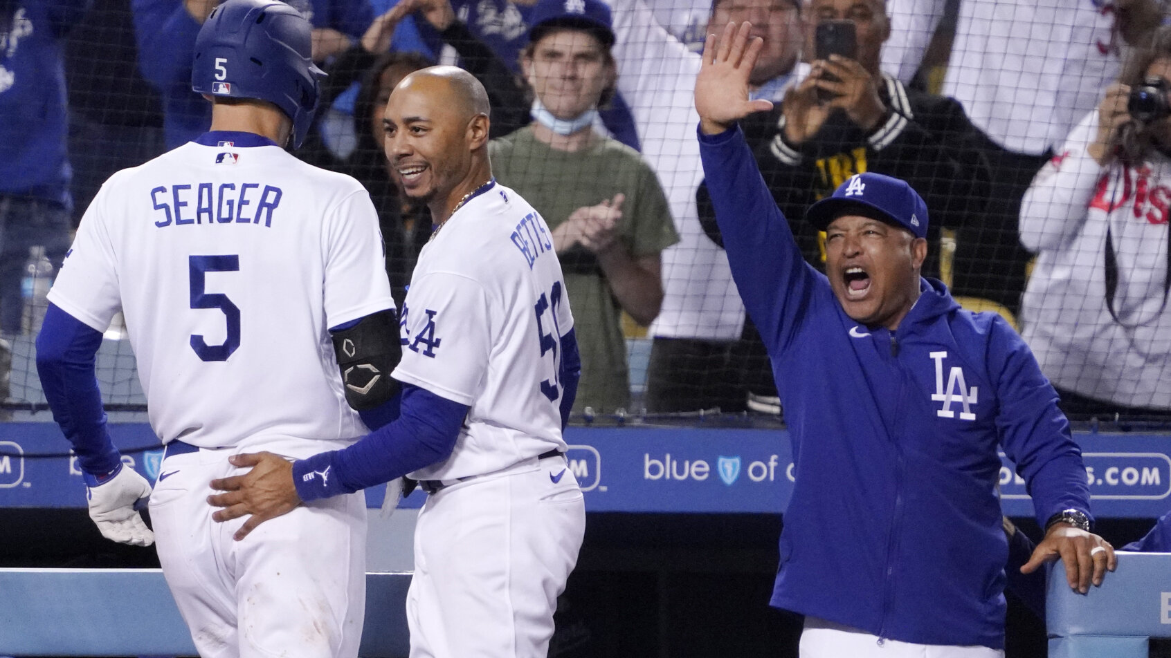 Corey Seager and Mookie Betts celebrate by the dugout
