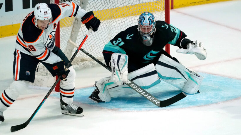 Philipp Grubauer waiting as Zach Hyman controls puck in front of the crease