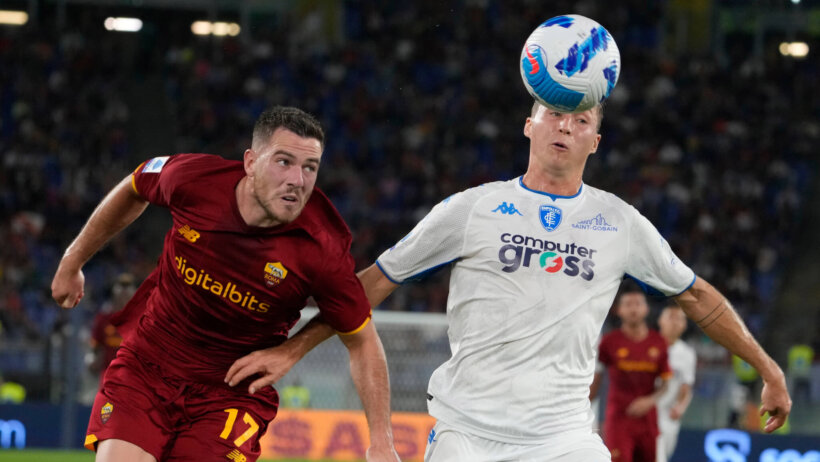 Player heading ball while being chased by defender