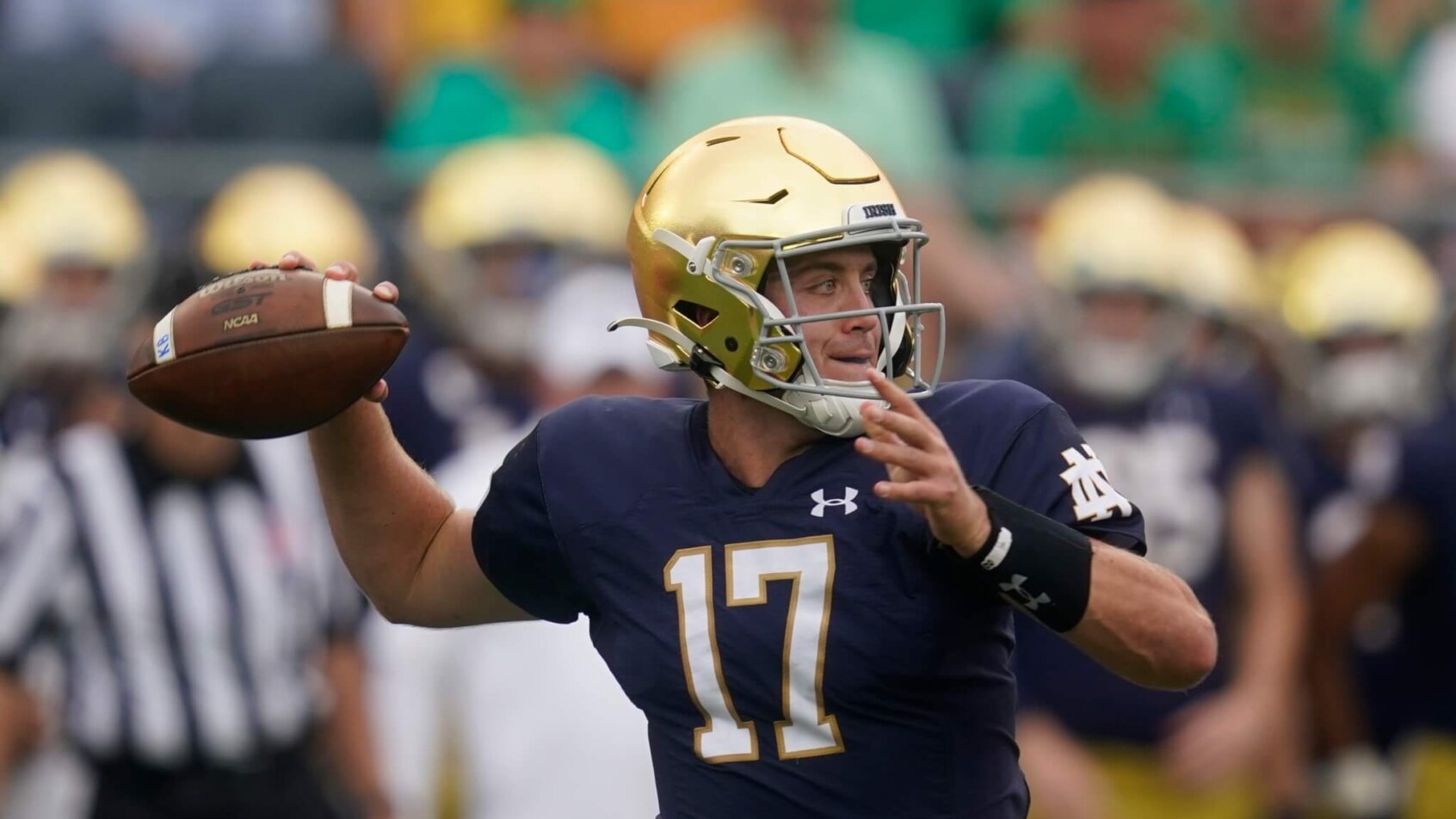 Notre Dame quarterback Jack Coan throwing the ball during a college football game.
