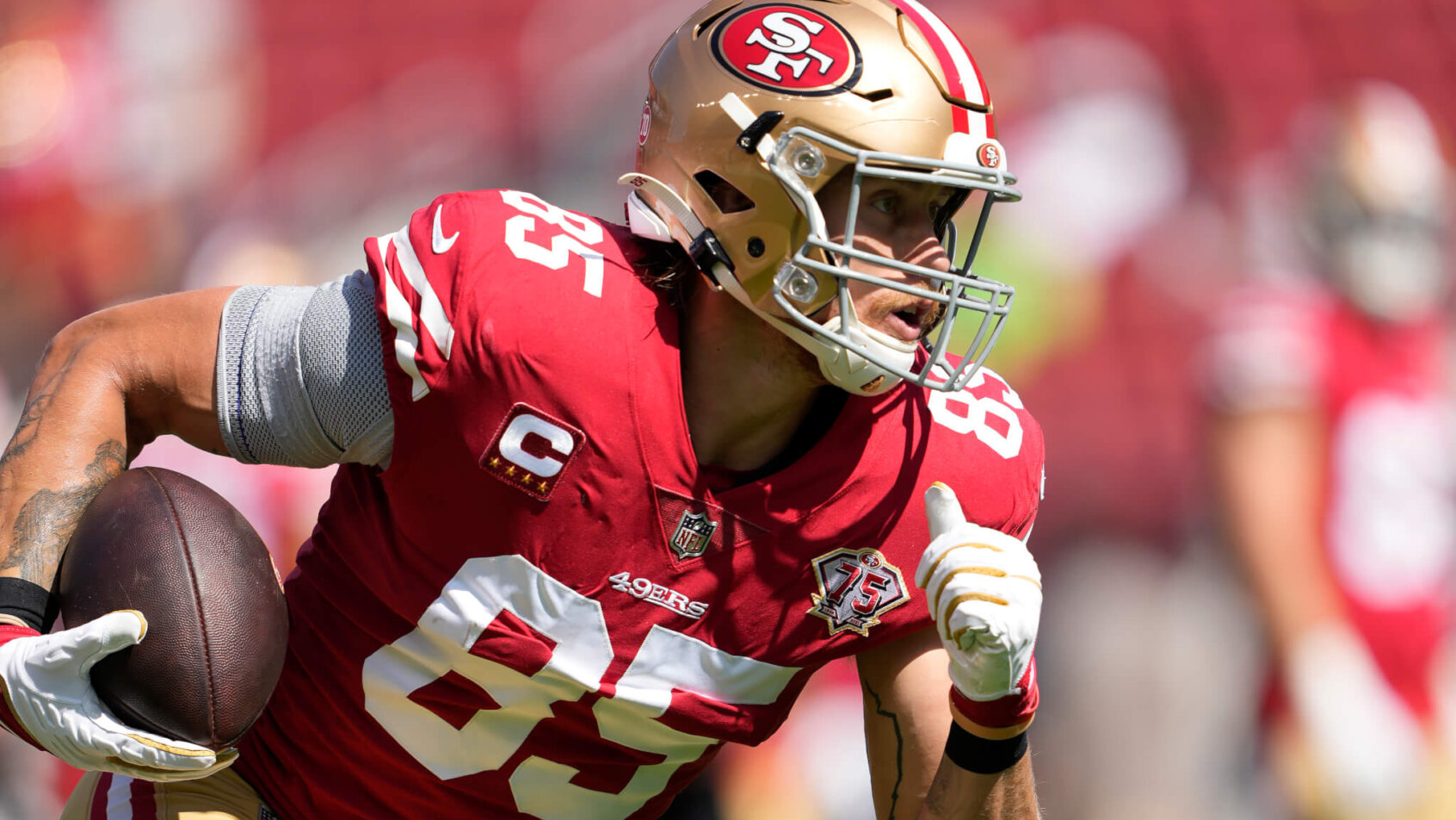 George Kittle runs after the catch