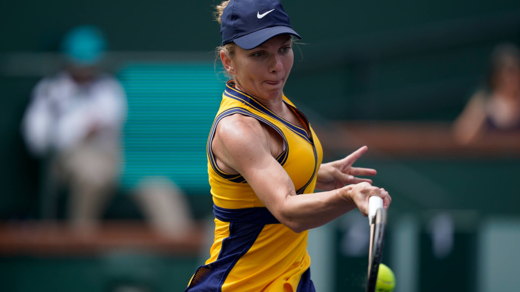 Simona Halep hitting a return shot during a tennis match.