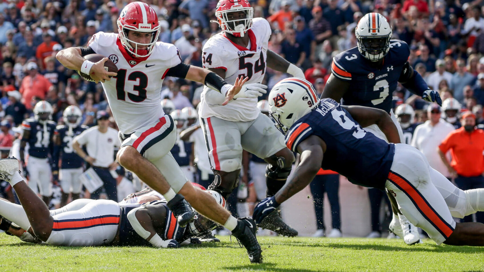 Georgia quarterback Stetson Bennett carrying the ball during a college football game.