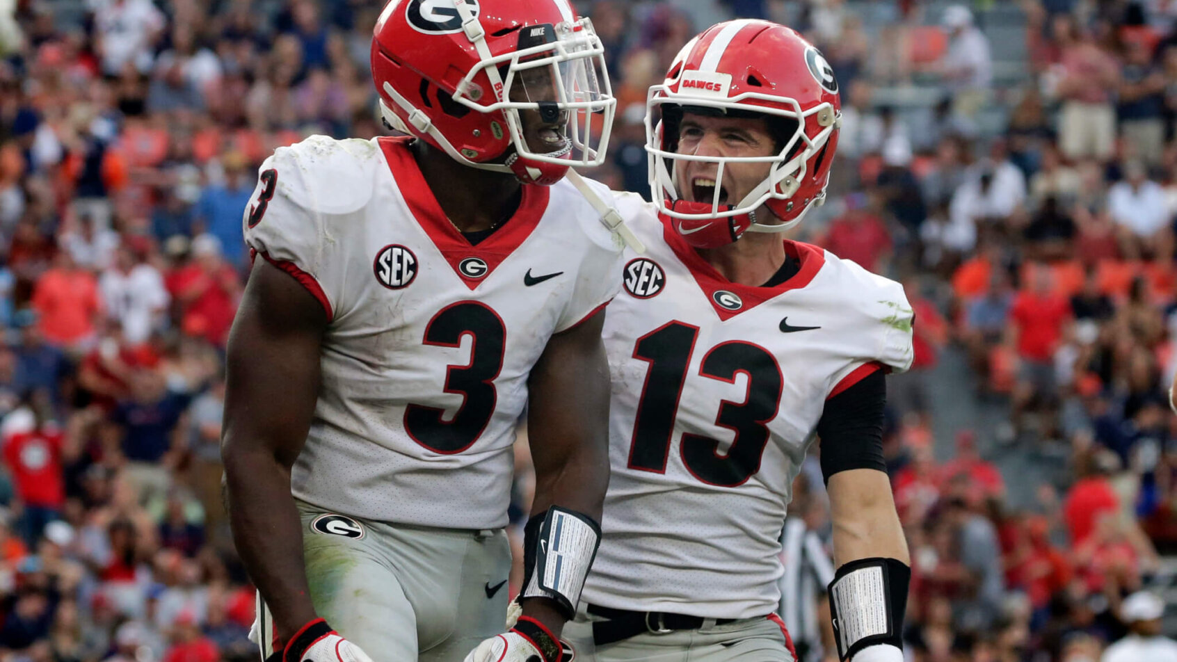 Georgia running back Zamir White celebrating with quarterback Stetson Bennett after scoring a touchdown.