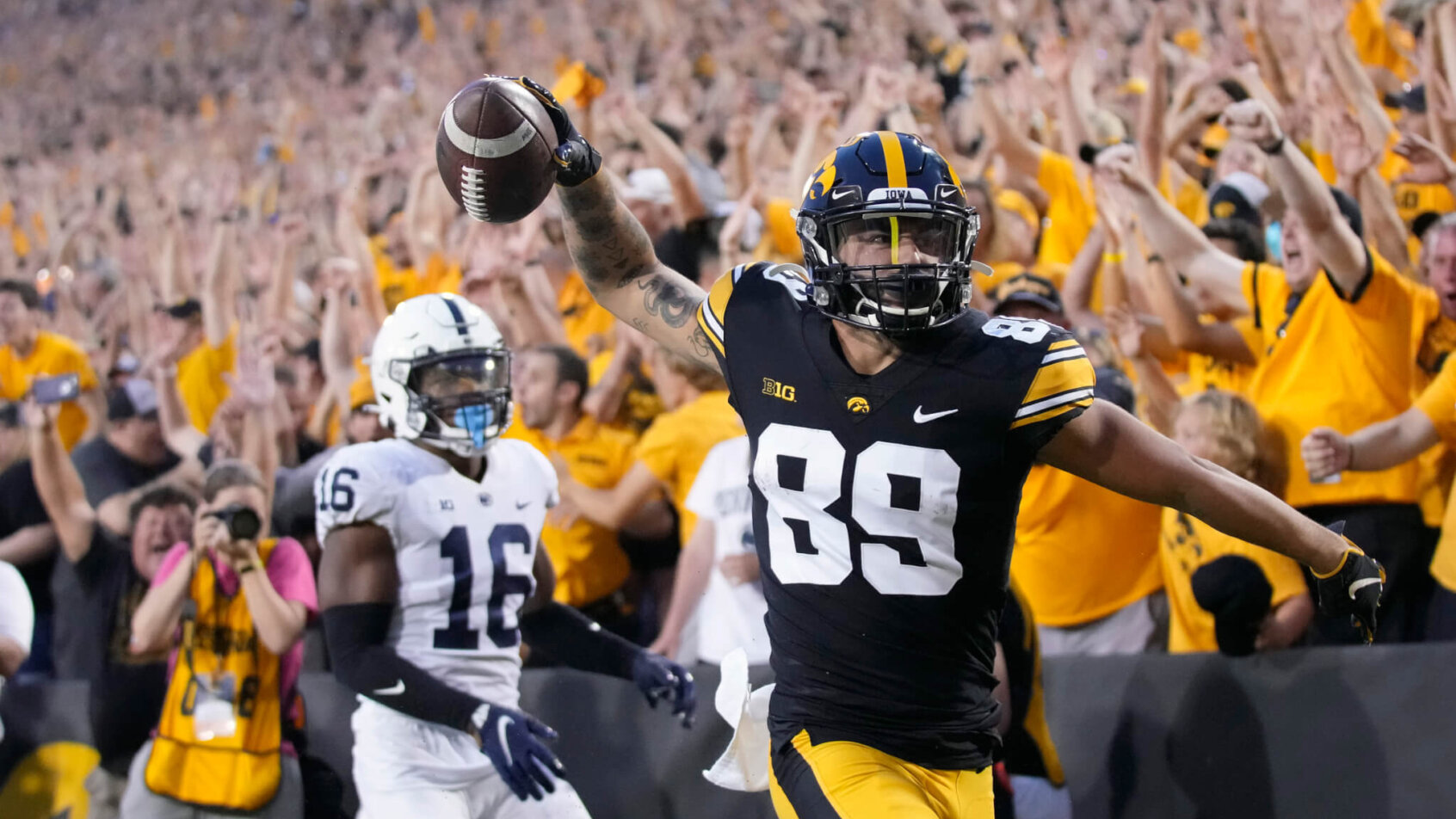 Iowa wide receiver Nico Ragaini reacting after scoring a touchdown during a college football game.