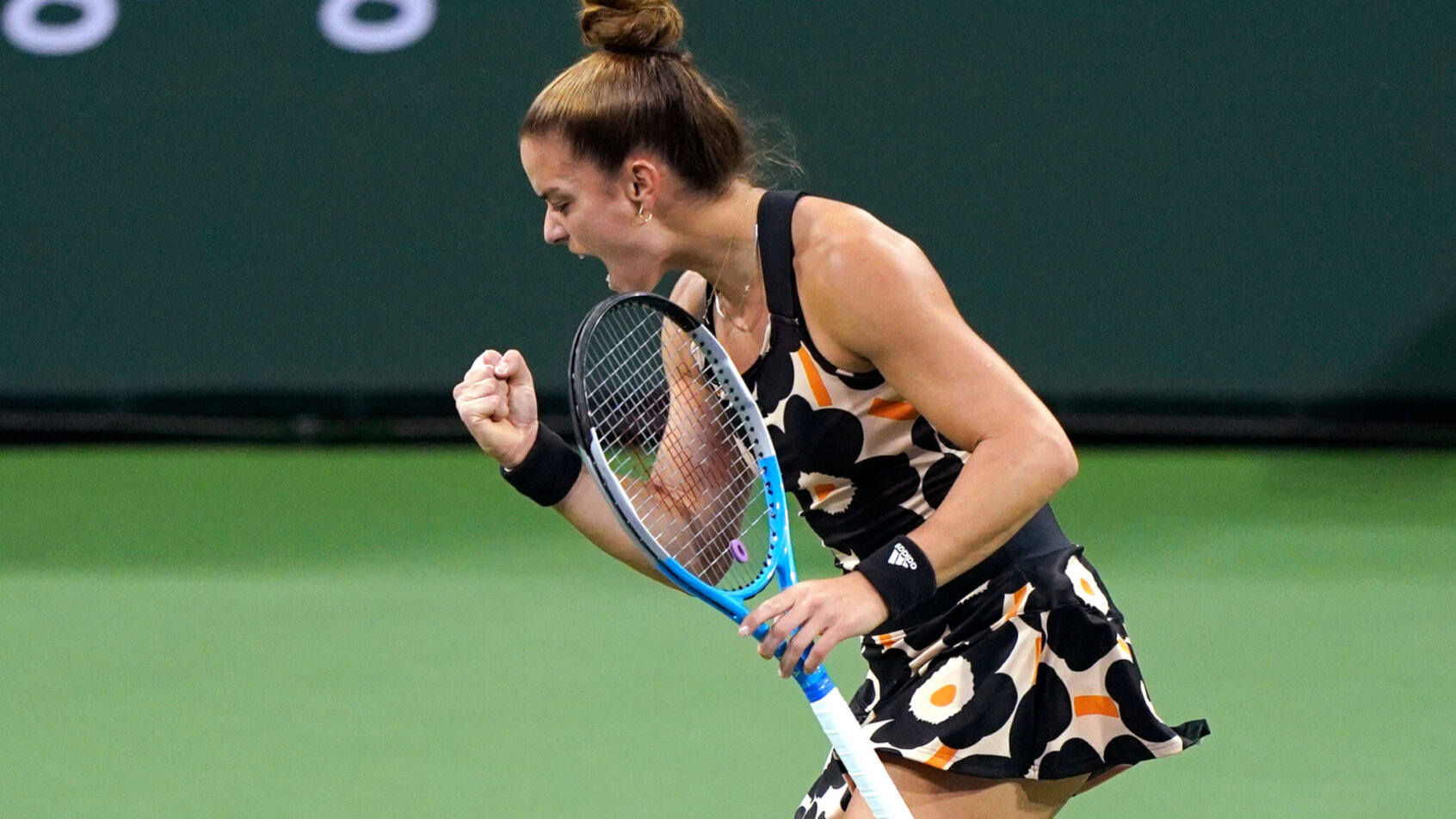 Maria Sakkari reacting to winning a point during a tennis match.