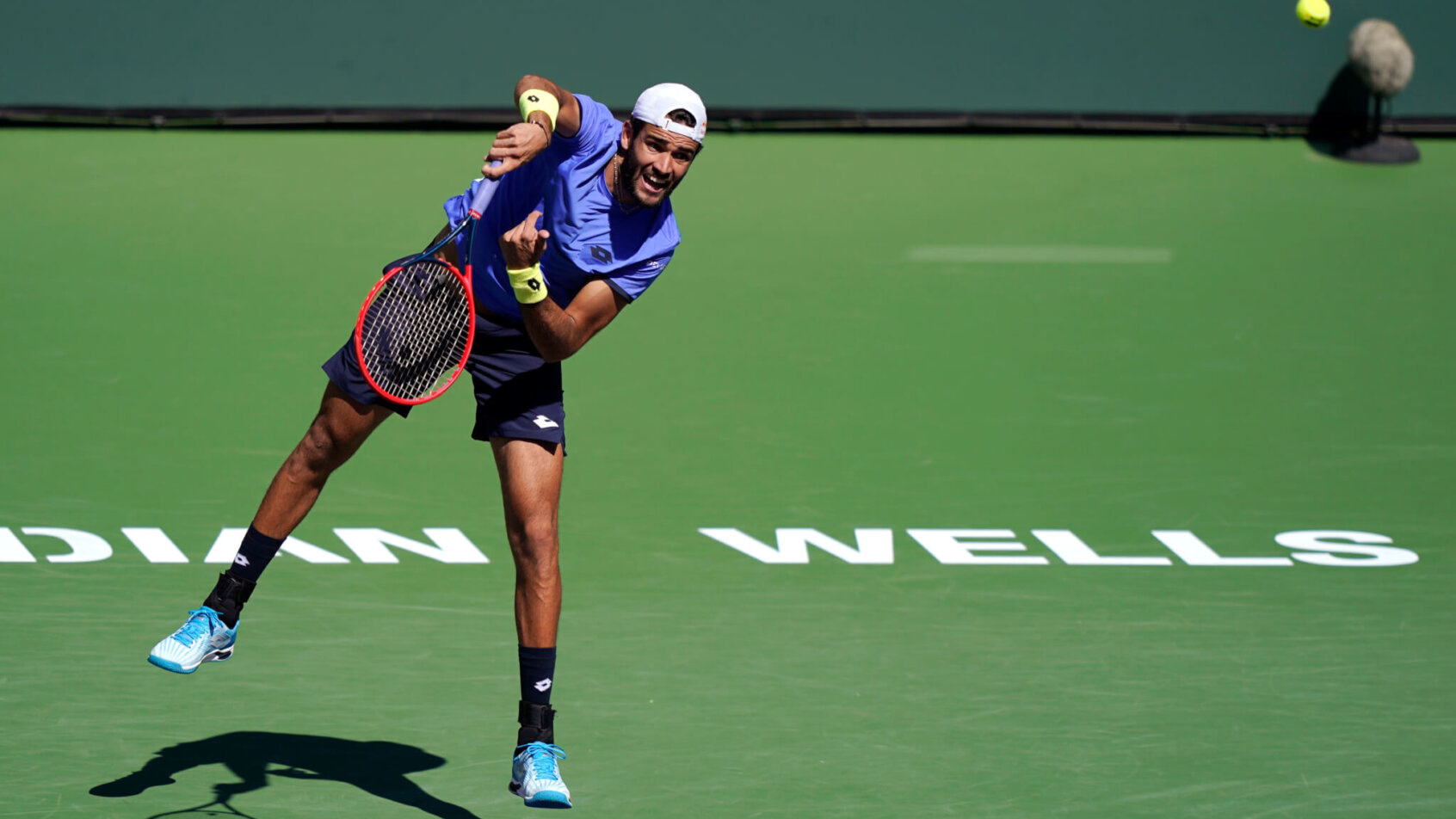 Matteo Berrettini serving the ball during a tennis match.