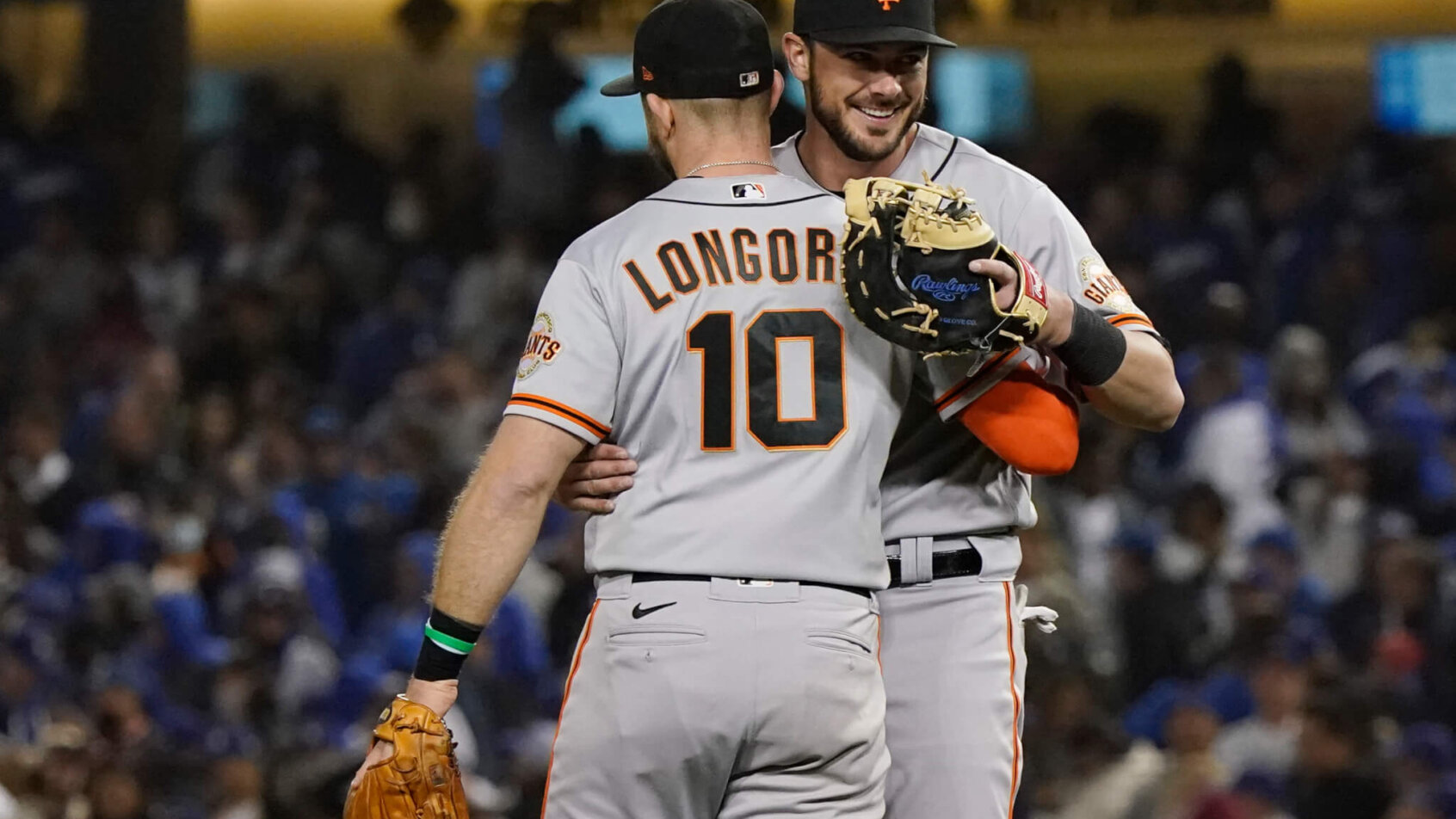 San Francisco Giants' Evan Longoria hugging teammate Kris Bryant