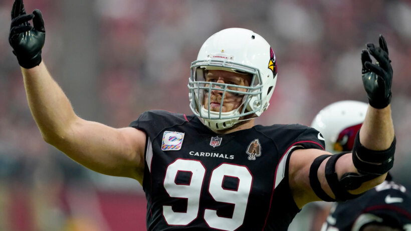 Arizona Cardinals defensive end J.J. Watt with his hands in the air during an NFL football game.