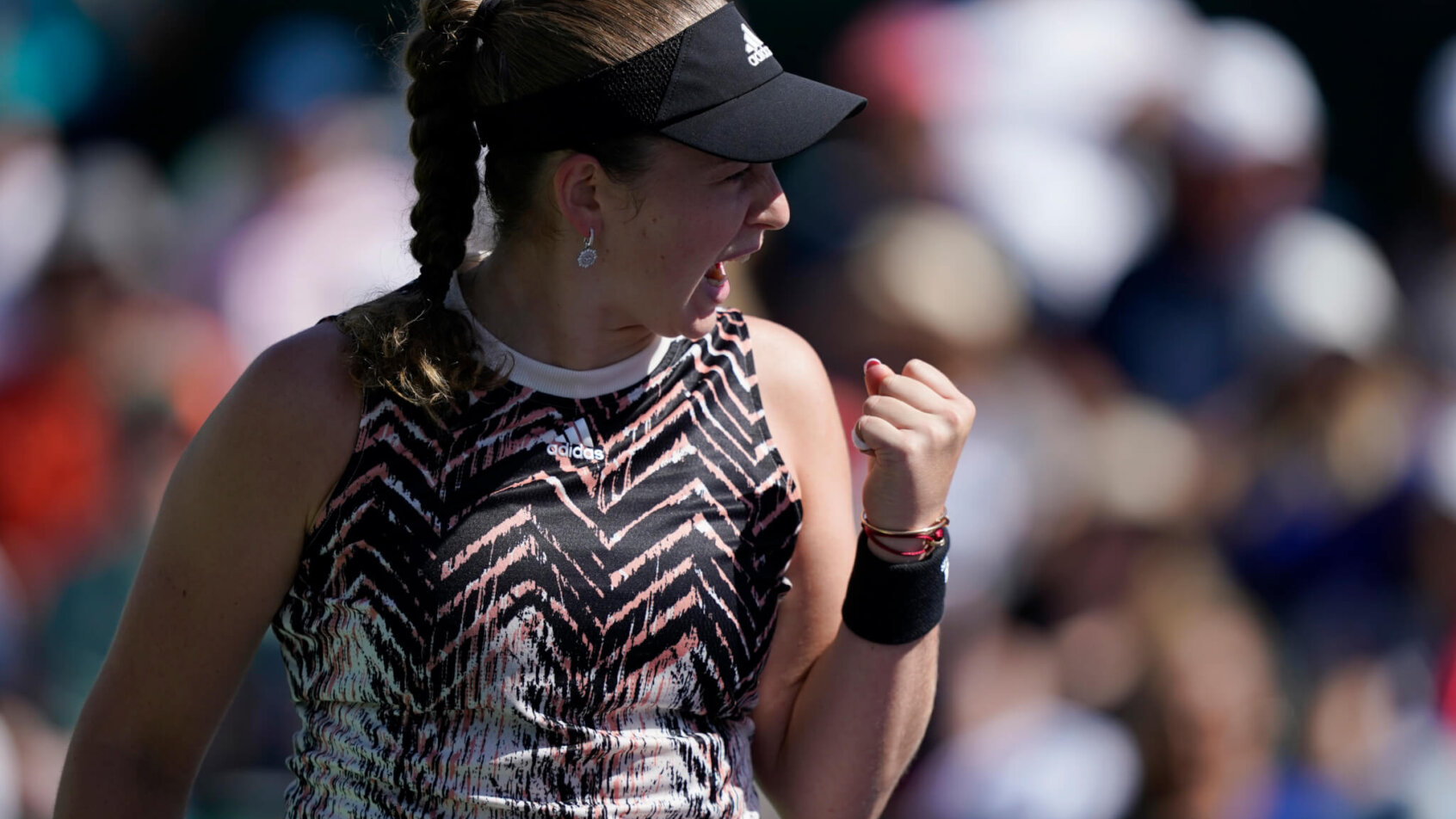 Jelena Ostapenko celebrating after winning a tennis match.