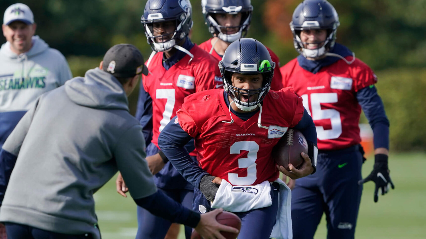 Russell Wilson running with football in left hand