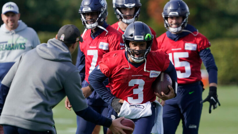 Russell Wilson running with football in left hand