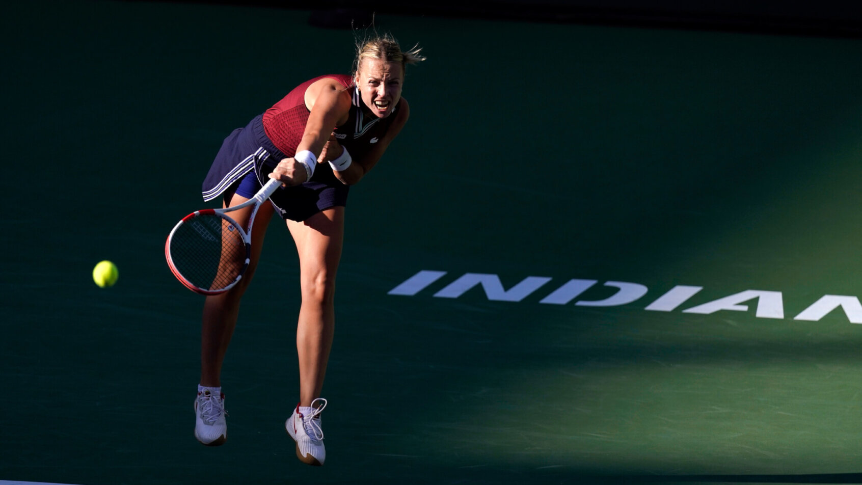 Anett Kontaveit serving the ball during a tennis match.
