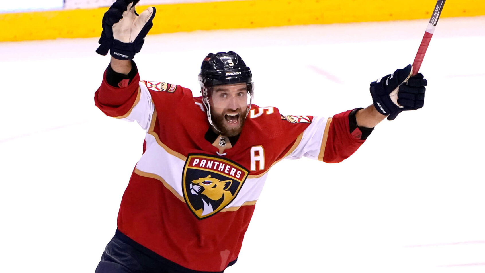 Florida Panthers defenseman Aaron Ekblad celebrating after his teammate scored a goal during an NHL hockey game.