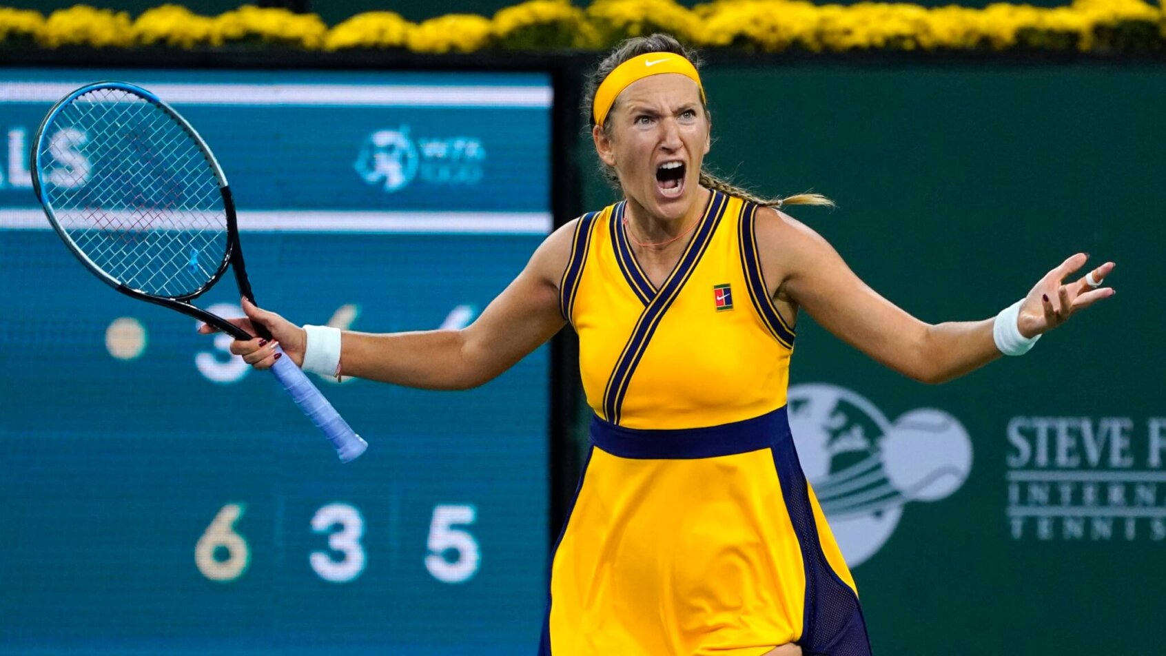 Victoria Azarenka celebrating after winning a tennis match.