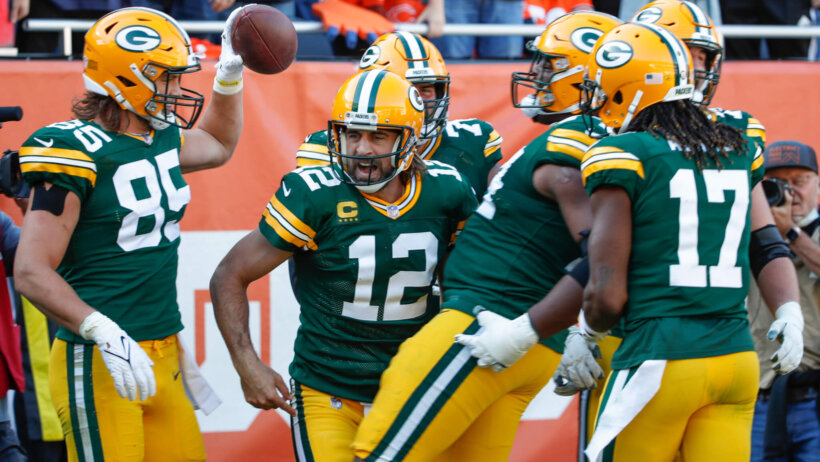 Green Bay Packers players celebrating after scoring a touchdown.