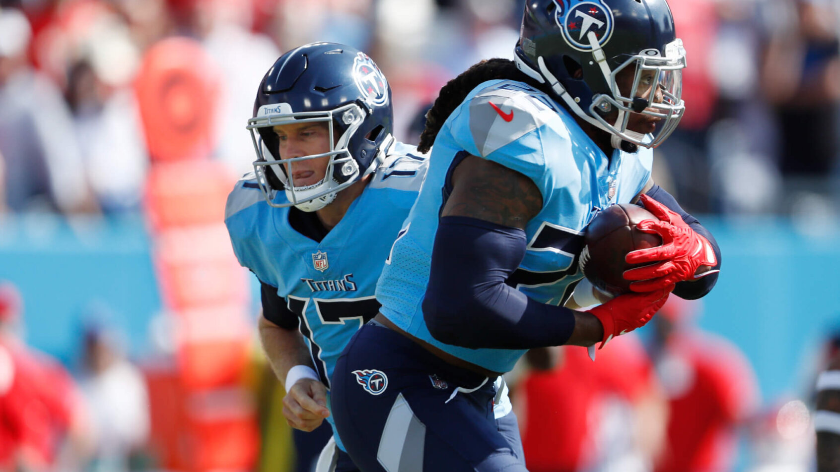 Tennessee Titans quarterback Ryan Tannehill handing the ball off during an NFL game.