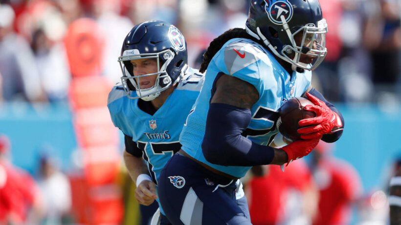Tennessee Titans quarterback Ryan Tannehill handing the ball off during an NFL game.