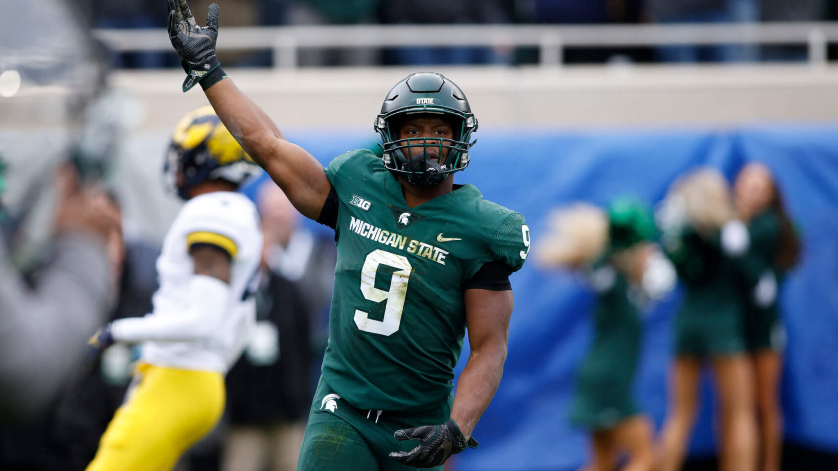Michigan State player Kenneth Walk III celebrating after scoring a touchdown.