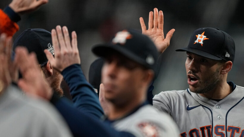 Carlos Correa high-fiving teammates