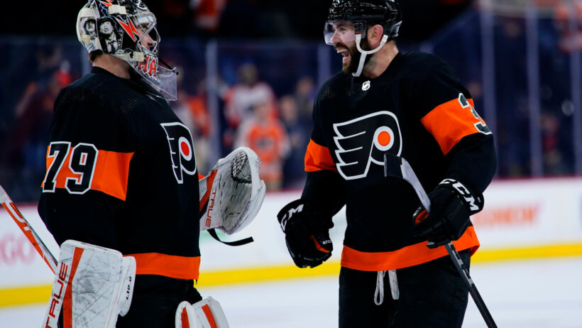 Carter Hart and Keith Yandle celebrate