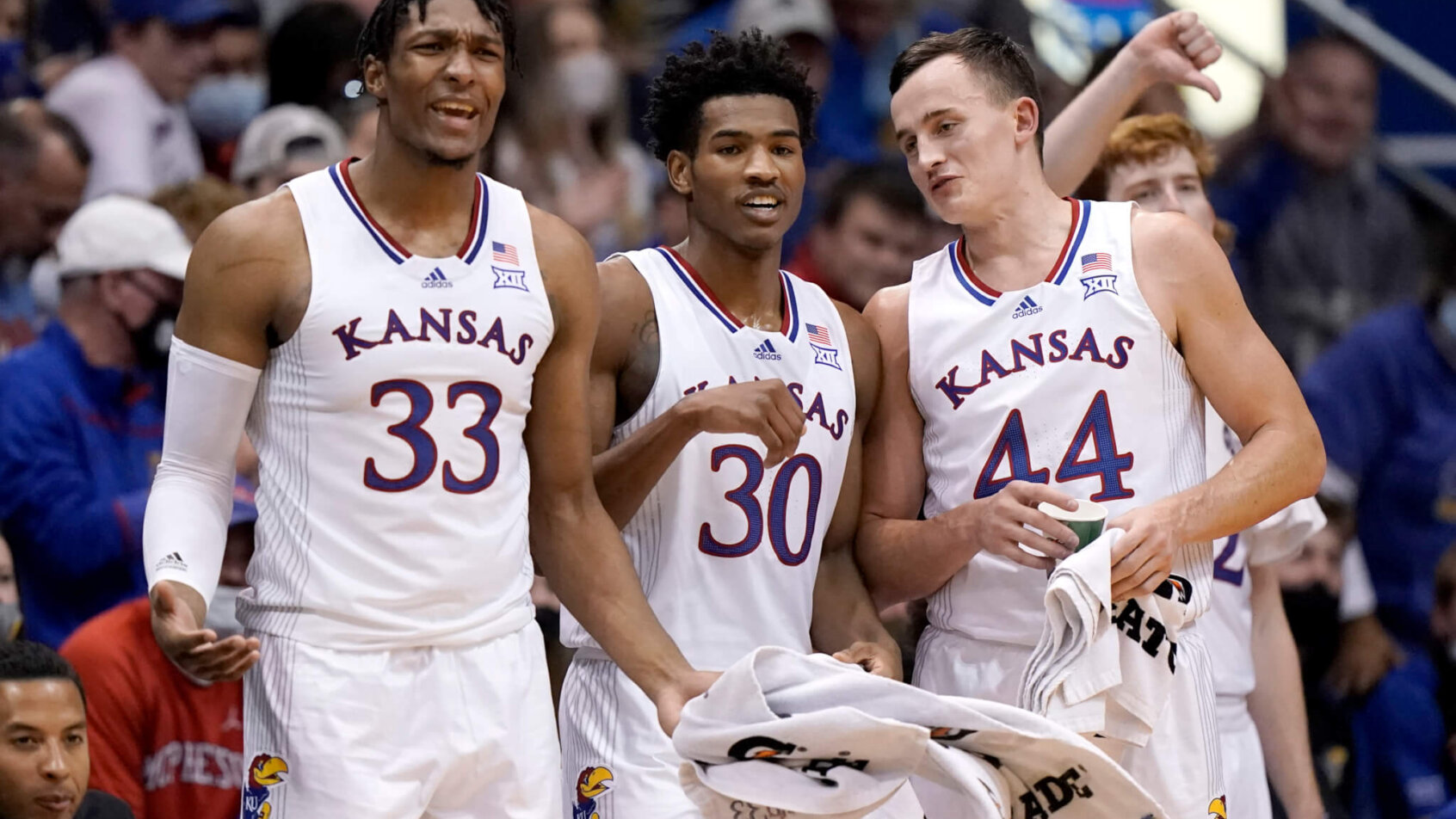 Kansas' David McCormack, Ochai Agbaji and Mitch Lightfoot on the bench