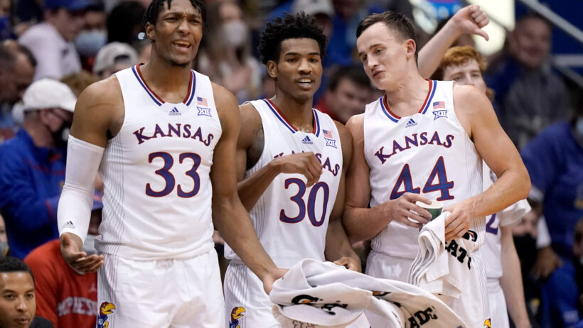 Kansas' David McCormack, Ochai Agbaji and Mitch Lightfoot on the bench