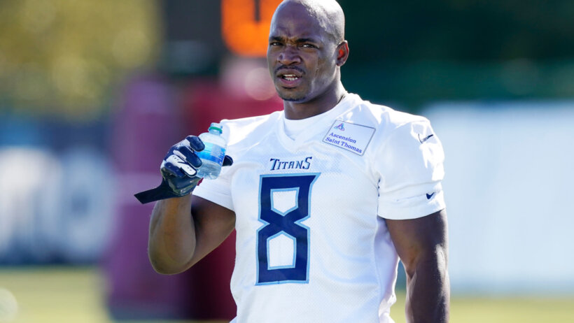 Adrian Peterson drinking water at practice