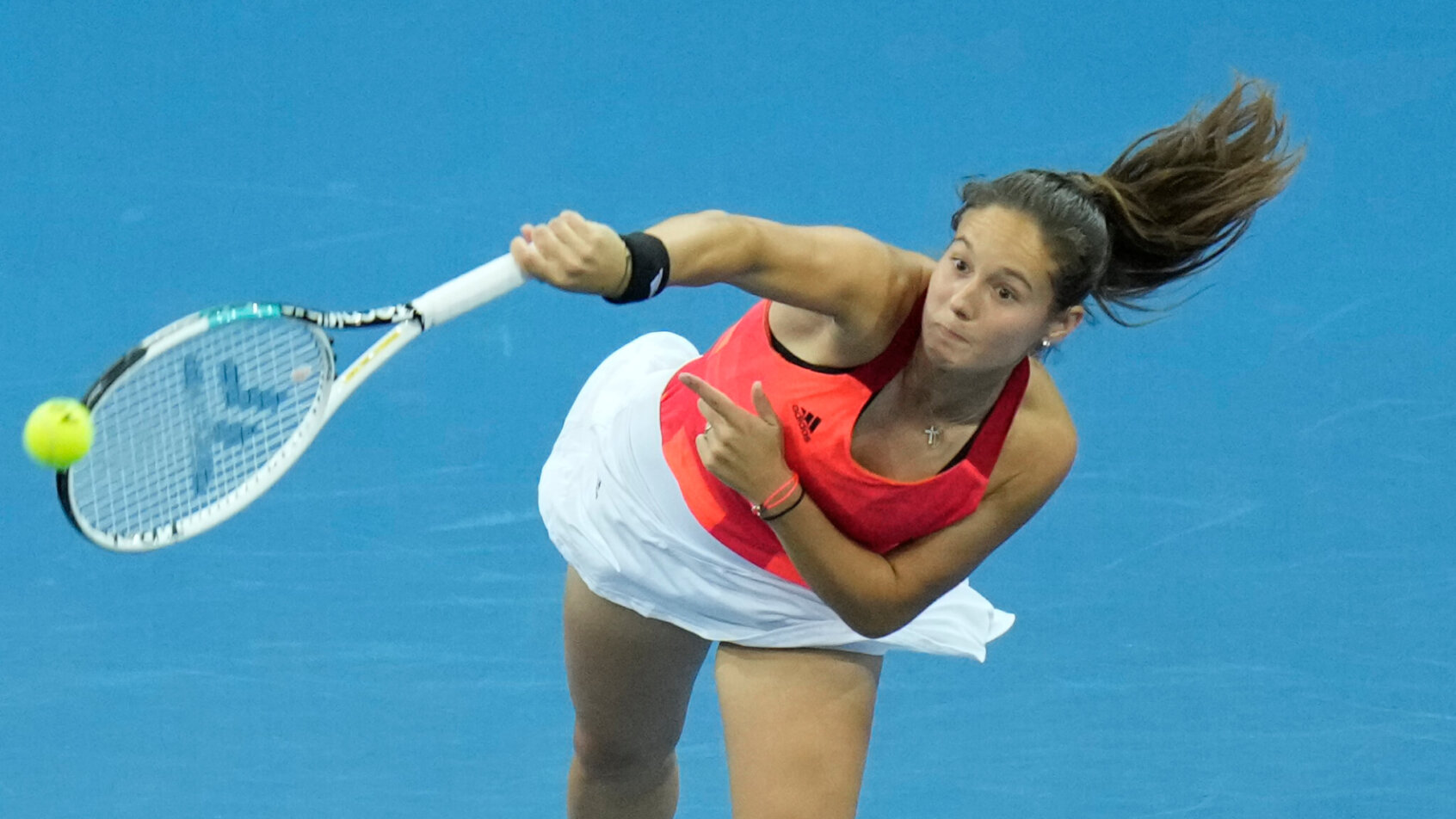 Daria Kasatkina serving the ball during a tennis match.
