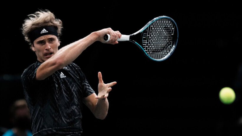 Alexander Zverev hitting a return forehand shot during a tennis match.